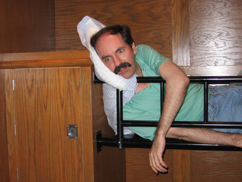 Brian pretends to nap in one of the U-boat bunks