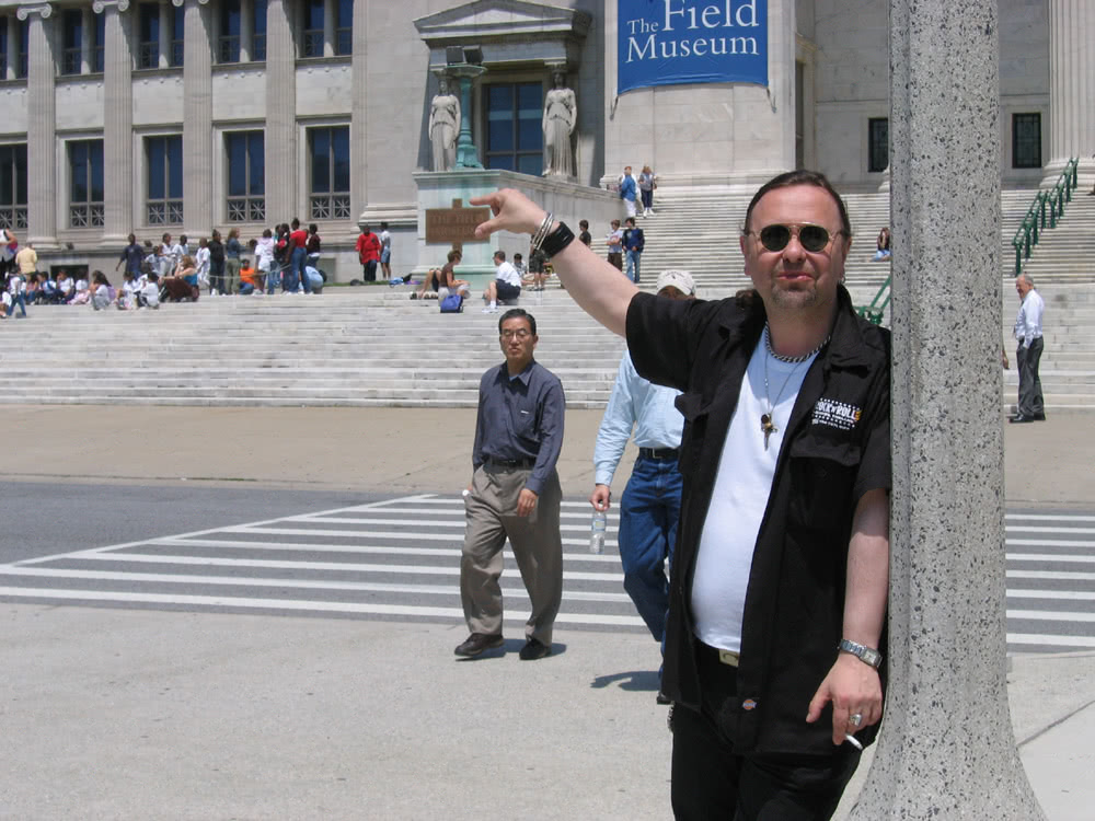 John posed to look as if his fingers are holding up the plaque for the Field Museum